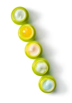 A set of five green jars with moisturizers for the face. The concept of natural Stock Photos