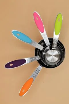 Set of five measuring cups used in cooking Stock Photos