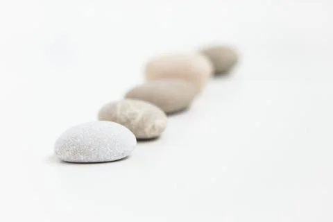 Set of five pebbles on the white background Stock Photos