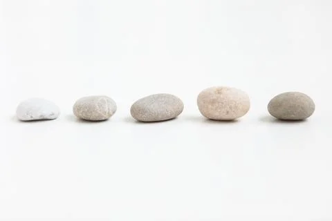 Set of five pebbles on the white background Stock Photos