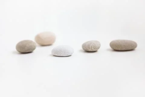 Set of five pebbles on the white background Stock Photos