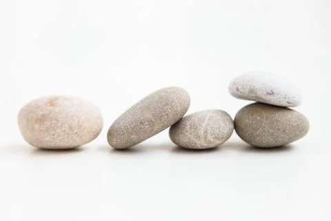 Set of five pebbles on the white background Stock Photos
