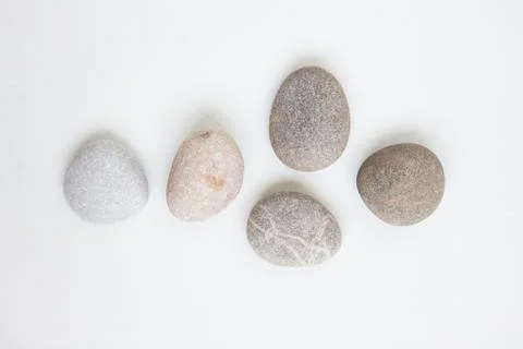 Set of five pebbles on the white background Stock Photos