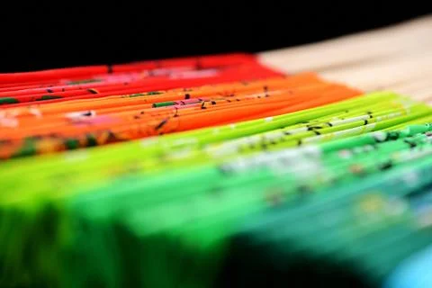 Set of folded multi-colored Vietnamese fans on a dark background close-up Stock Photos