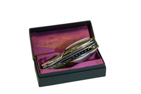 Set of folding knife, fork, spoon, corkscrew five in one in a gift box. Stock Photos