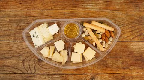 Set of food in a plastic container. Cheese plate for a picnic Stock Photos