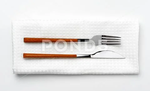 Set of fork and knife on towel. Isolated on white background. Stock-Fotos
