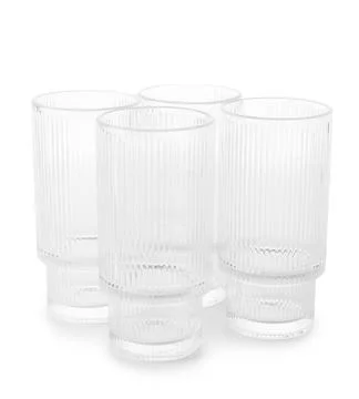 Set of four clear ribbed drinking glasses Stock Photos