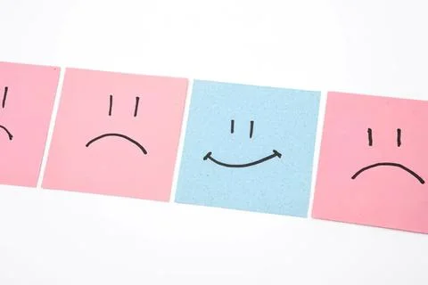 Set of four colorful sticky notes with happy and sad faces Stock Photos