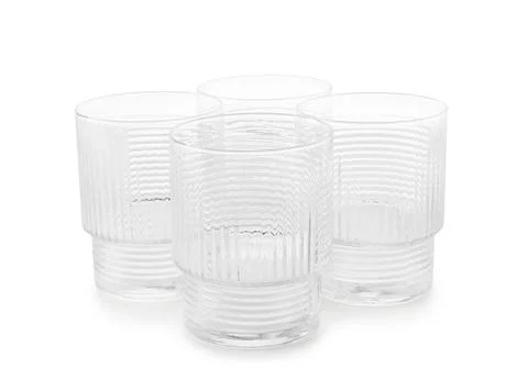 Set of four empty textured drinking glasses Stock Photos