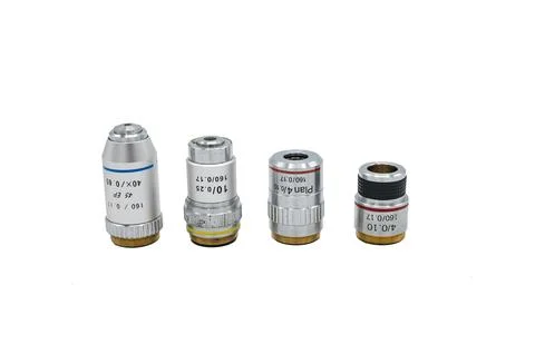 Set of four microscope lenses on a white background, there are approach and Stock Photos