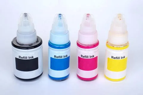 Set of four refill ink bottles in CMYK colors—black, cyan, magenta, and yellow—a Stock Photos
