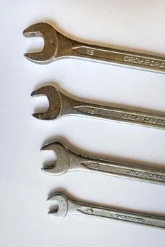 Set of four silver wrenches or spanners, isolated on white background. 写真素材
