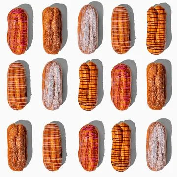 Set of fresh eclairs with original decor on a white background. pattern with  Photos