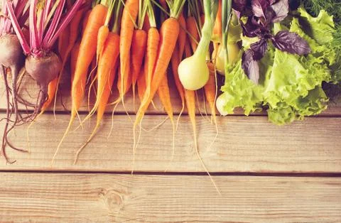 Set of fresh raw vegetables on old wooden background. Copy space. Top view. V Stock Photos