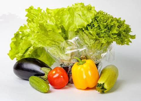 Set of fresh raw vegetables on a white background. Salad, tomatoes, cucumbers Stock Photos