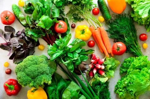 Set of fresh vegetables on gray background. Aromatic herbs, onion, avocado Stock Photos