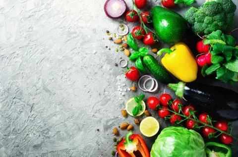Set of fresh vegetables on grey background. Aromatic herbs, onion, avocado Stock Photos