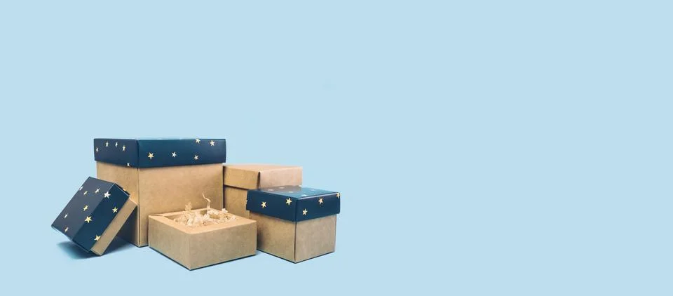 Set of gift boxes with blue covers with stars on light blue Stock Photos