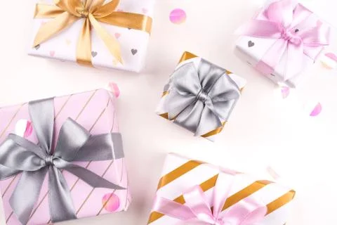 Set of gift boxes with bows and confetti on a white background. Stock Photos