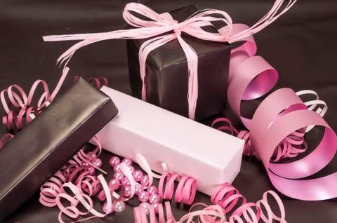 Set of gift boxes with bows, beads and ribbons on a colored background Stock Photos