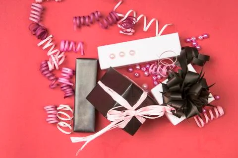Set of gift boxes with bows, beads and ribbons on a colored background Stock Photos