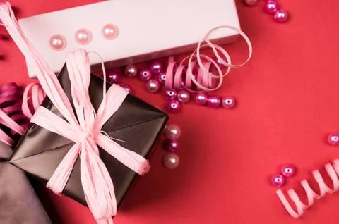 Set of gift boxes with bows, beads and ribbons on a colored background Stock Photos