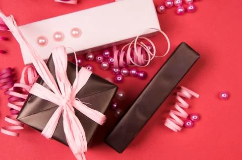 Set of gift boxes with bows, beads and ribbons on a colored background Stock Photos