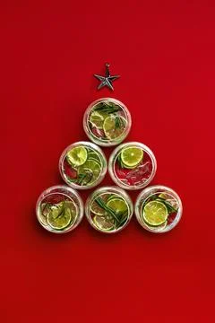 Set of glasses arranged as the Christmas tree with golden star on red background Foto stock