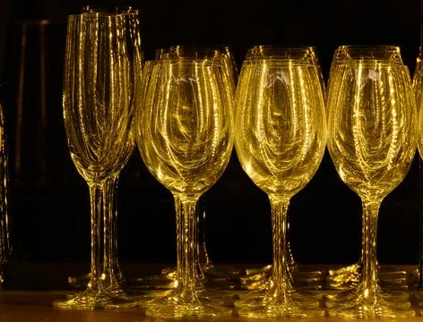 Set of glasses for different alcoholic drinks and cocktails on wood shelf bac Stock Photos