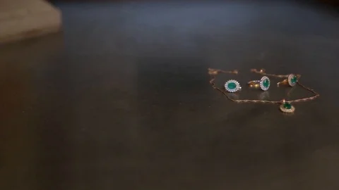 Set of gold earrings, ring and pendant with emeralds Stock Footage 90215671