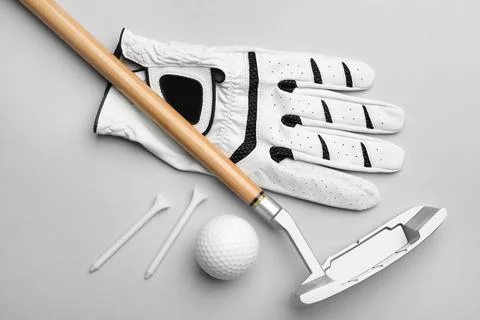 Set of golf equipment on grey background, flat lay Stock Photos