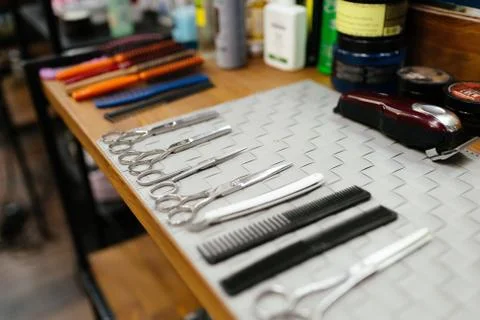 Set of hairdressing tools on table. Clean metal scissors Stock Photos