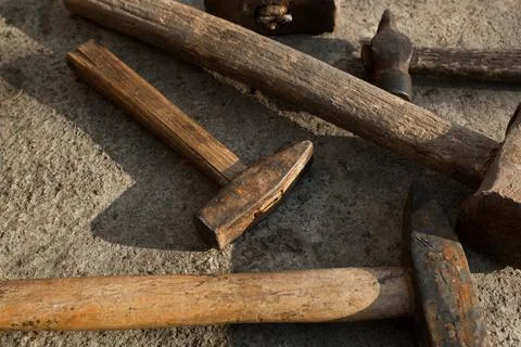 Set of hammers of different sizes on concrete pavement Stock Photos