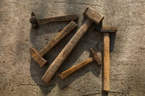 Set of hammers of different sizes on concrete pavement Stock Photos