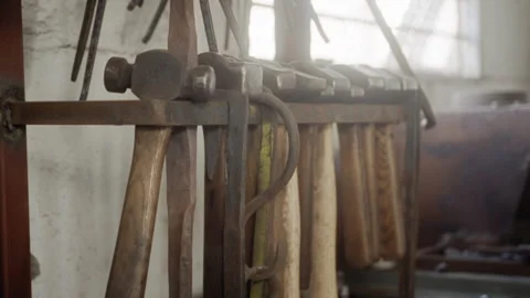 Set of hammers hanging in a rack in a workshop Video stock 274996452
