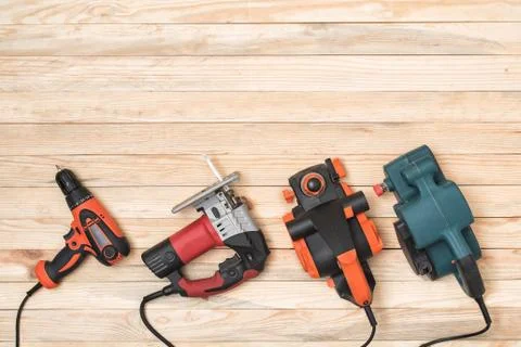 Set of hand carpentry power tools for woodworking lies on a light wooden back Стоковые фото