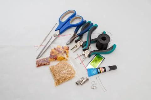 Set for handcraft, making of bijouterie, amber colored beeds, scissors Stock Photos