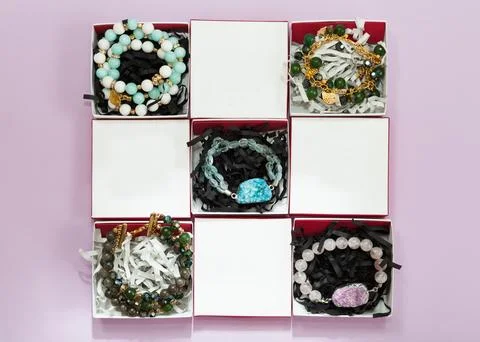 Set of handmade bracelets in white boxes Stock Photos