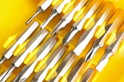 Set of heads for screwdriver (bits) in box. Set of working tools and bits. Stock Photos