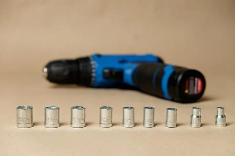 Set of hexagonal sockets  featuring battery-operated screwdriver Stock Photos