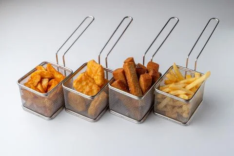 Set of hot deep fried beer snacks: crispy chicken nuggets, french fries and c Stock Photos