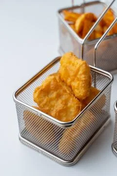 Set of hot deep fried beer snacks: crispy chicken nuggets, french fries and c Stock Photos