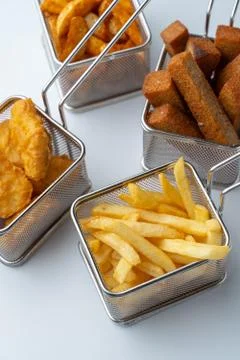 Set of hot deep fried beer snacks: crispy chicken nuggets, french fries and c Stock Photos