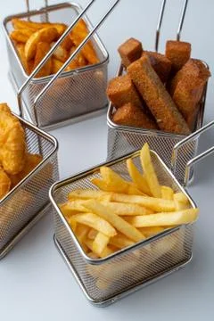 Set of hot deep fried beer snacks: crispy chicken nuggets, french fries and c Stock Photos
