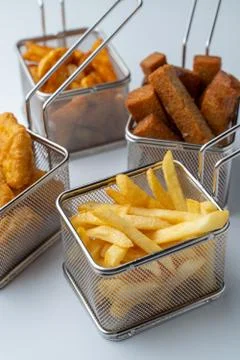 Set of hot deep fried beer snacks: crispy chicken nuggets, french fries and c Stock Photos