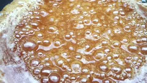 Set the hot pan, simmering palm sugar. Stock Footage 131808463