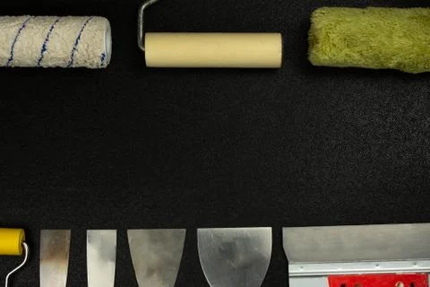 Set of house painter tools on black background with copy space, top view, fla Stock Photos
