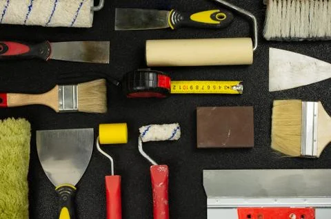 Set of house painter tools on black background, top view, flat lay Stock Photos