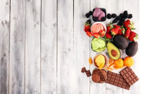 Set of ice cream scoops of different colors and flavours with berries, chocol Stock Photos